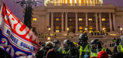 Protestors in Washington D.C. during the January 6th raid on the Capitol get pushed out by officers.