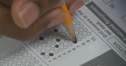 A student anxiously bubbles in a scantron on a standardized test.