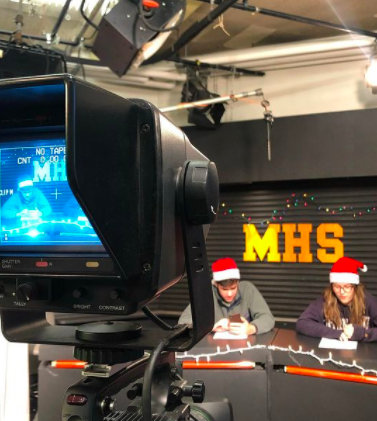 A shot from 2019 of two students recording a winter special of MHS Info.