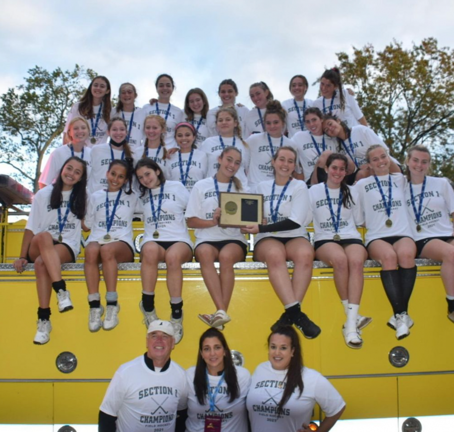 The+Varsity+Field+Hockey+team+smiles+with+their+Section+1+Championship+plaque.