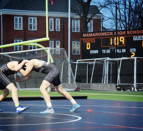 Two student wrestlers face off on the MHS turf during the MHS match against New Rochelle.
