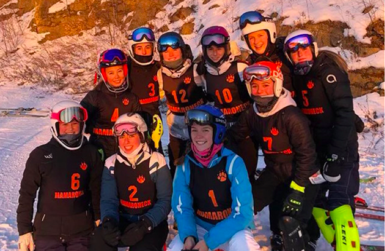 The Varsity Ski team smiles at Thunder Ridge Ski Area as they enjoy another great day of skiing.