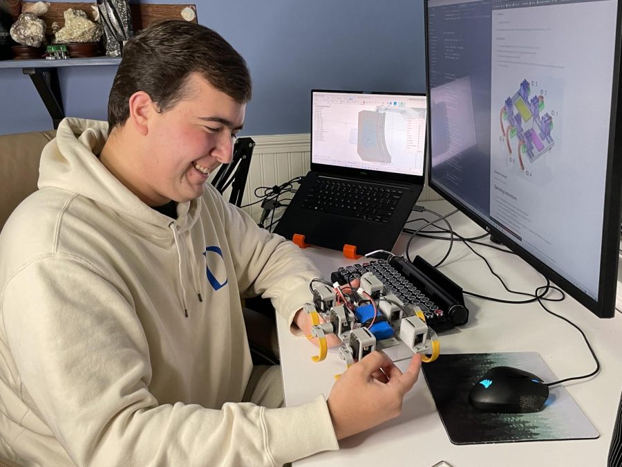 Jerry Orans (‘22) marvels over RHex that landed him among finalists of the Regeneron competition.