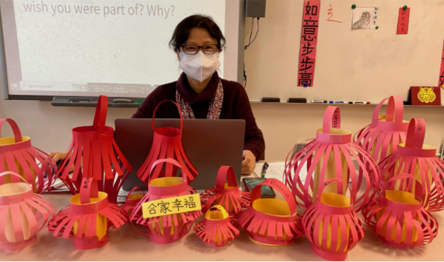 A shot of Michelle Liu displaying Chinese New Year decorations made by her students.