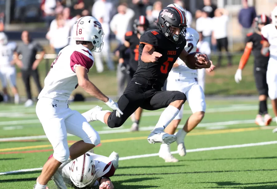 Jason Cox, winner of the Charles E. Lanza award for best overall athlete, hurdles over a Scarsdale defender at a game on October 22nd, 2022.