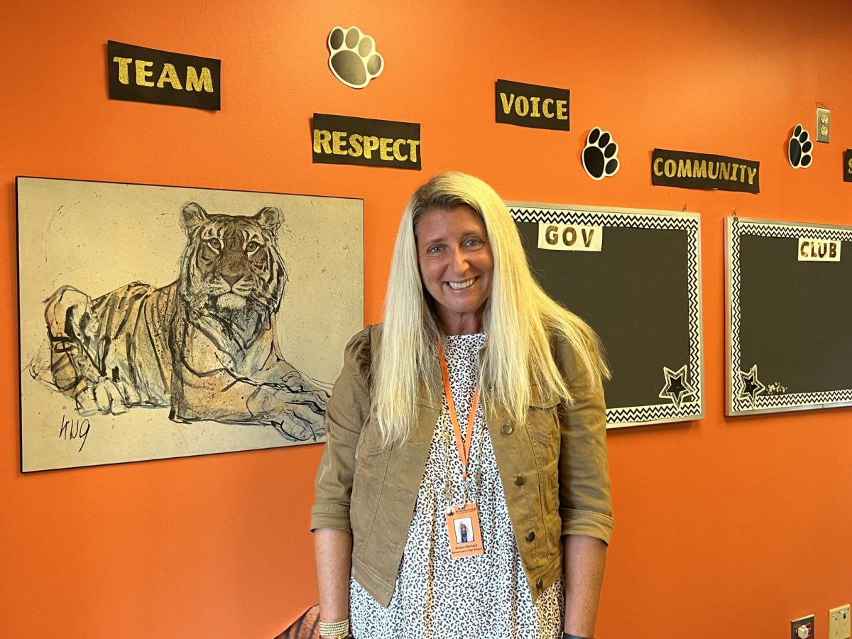 Barnard stands along the wall of her newly redecorated office in Mamaroneck High Schools overpass, a central location for students.