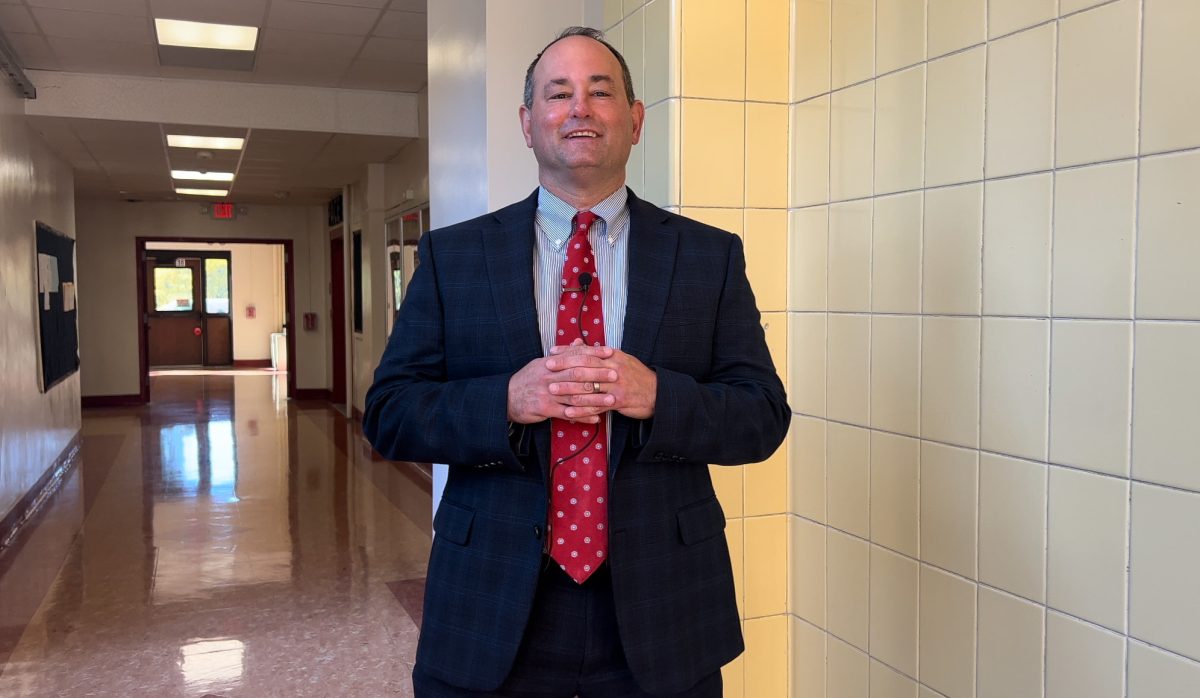 Sampson stands in the halls of Mamaroneck High School's Palmer Building.