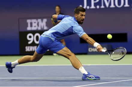 Novak Djokovic lunging for a shot.