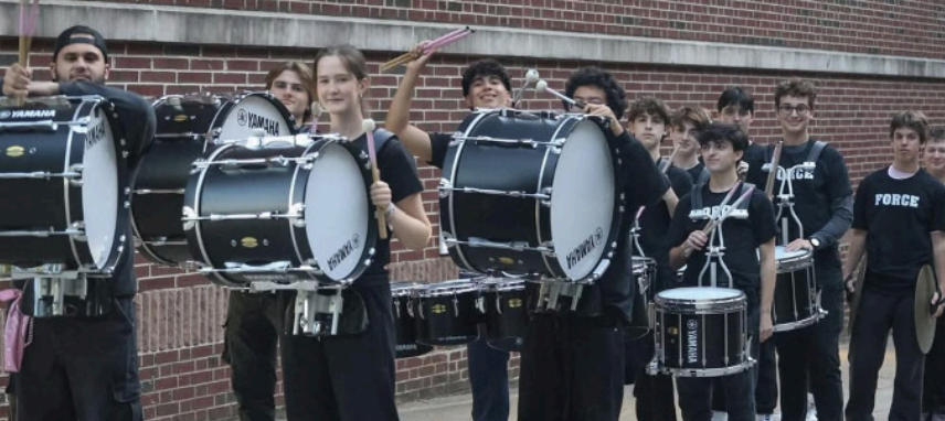 The Force with a smiles on their faces after performing the halftime show at a MHS football game