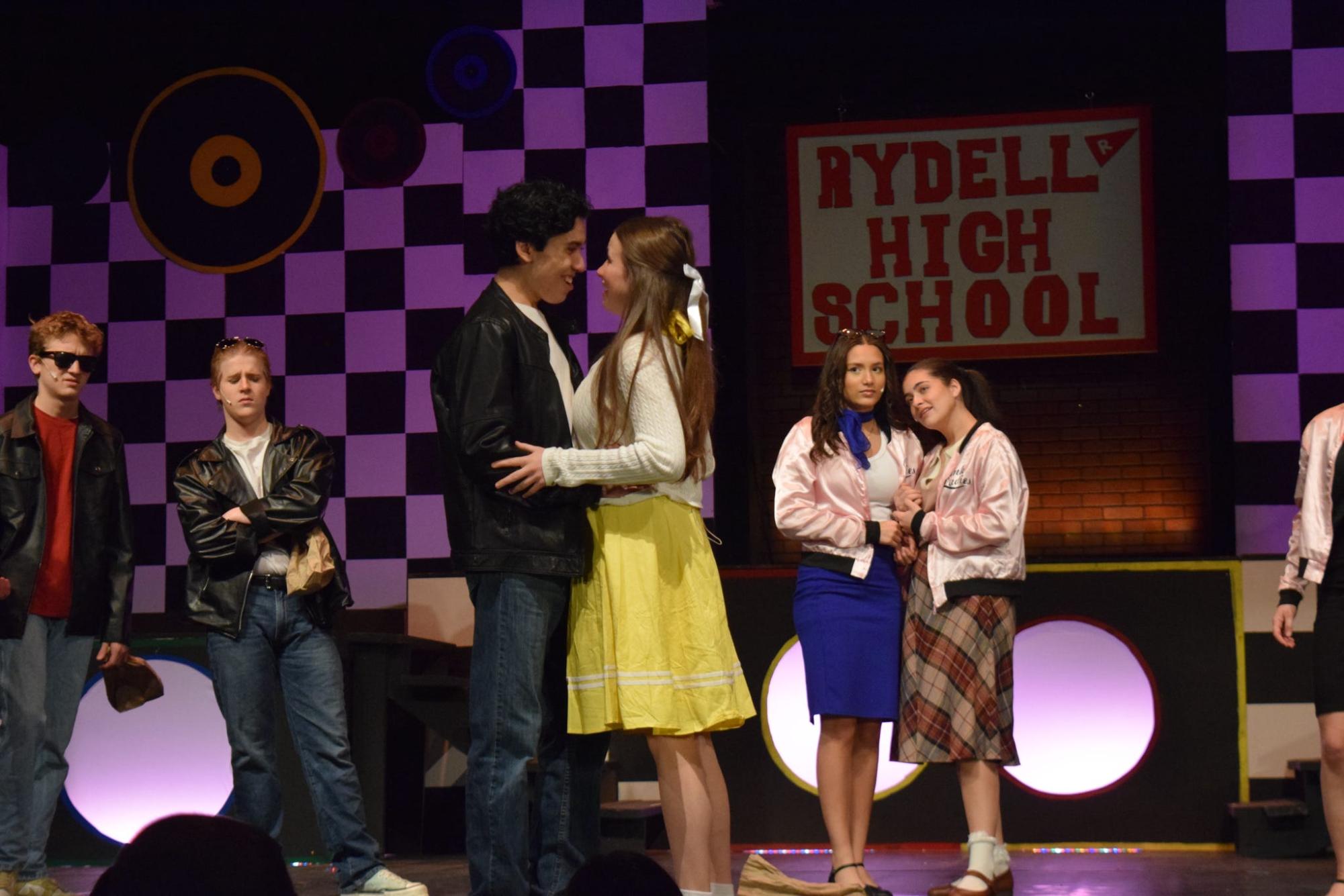 Sandy, Florence Haines ('25), and Danny, Jason Robalino ('25), embrace in this year's school musical Grease! 