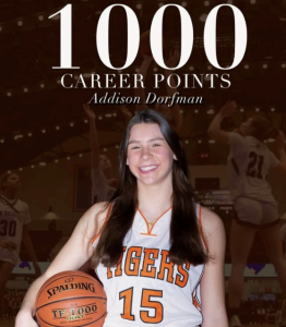 Dorfman posing with the esteemed 1000 point legacy basketball.