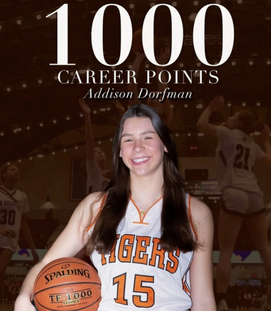 Dorfman posing with the esteemed 1000 point legacy basketball.